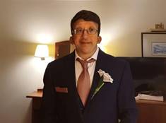 A person wearing a suit and tie  Description automatically generated